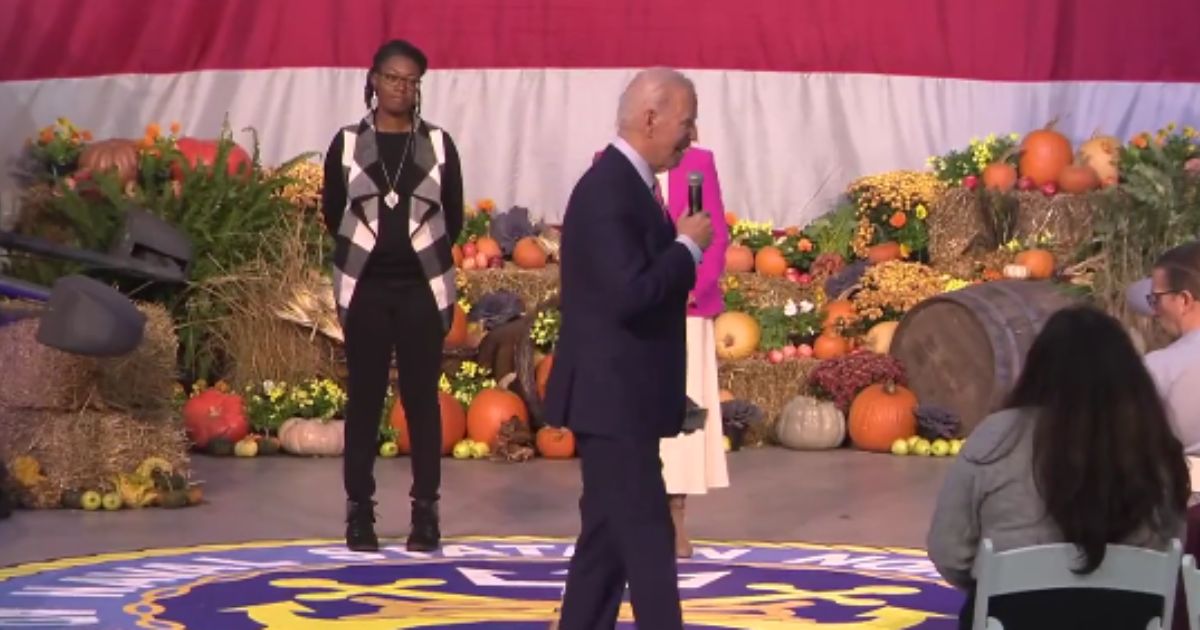 President Joe Biden attempts to talk to a little girl during a Thanksgiving event.