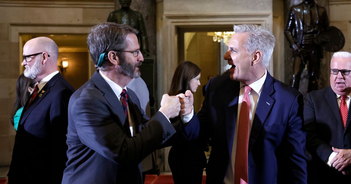 U.S. Speaker of the House Kevin McCarthy (R-CA) gives Rep. Tim Burchett (R-TN) a fist bump after a bill signing ceremony for H.J. Res. 26 at the U.S. Capitol Building on March 10, 2023 in Washington, DC.