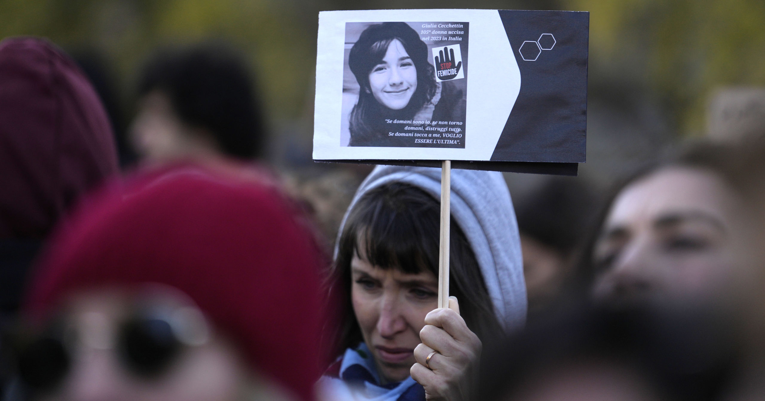 A woman shows a photo of Giulia Cecchettin, allegedly killed by ex-boyfriend, on the occasion of International Day for the Elimination of Violence against Women, in Milan, Italy, Saturday, Nov.25, 2023.