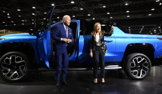 President Joe Biden, with General Motors CEO Mary Barra, looks at a Chevrolet Silverado EV as he tours the 2022 North American International Auto Show in Detroit on Sept. 14.