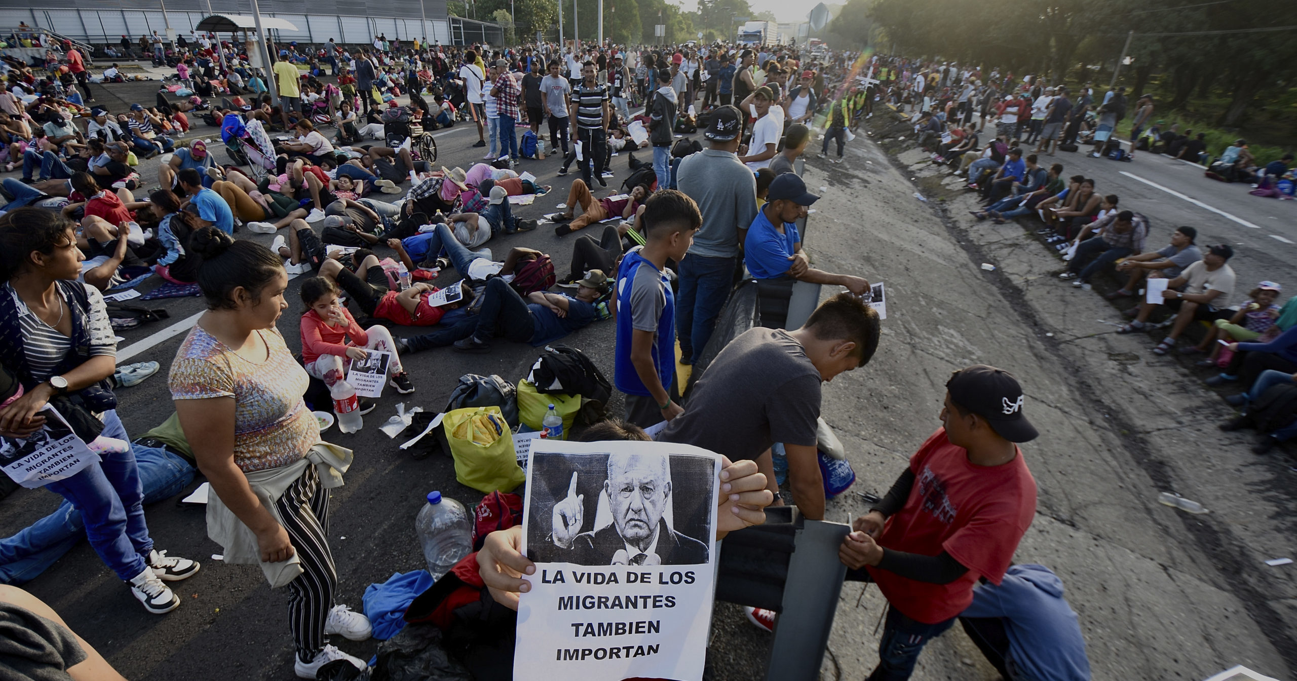 A migrant caravan heading for the U.S. stops to block a highway in Huixtla, Mexico, on Wednesday.