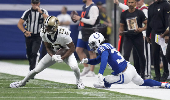 New Orleans Saints wide receiver Michael Thomas (13) sheds the tackle of Colts cornerback Tony Brown during the first half of an NFL game Oct. 29 in Indianapolis.