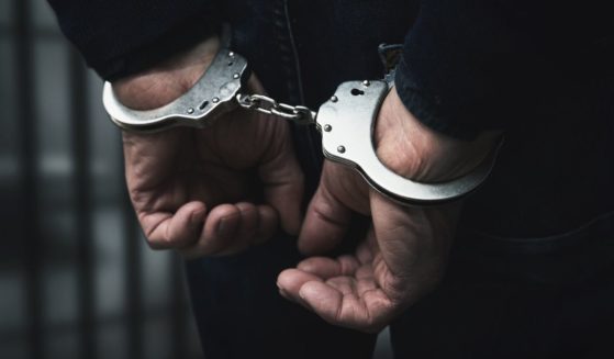 A man in handcuffs is seen in the above stock image.