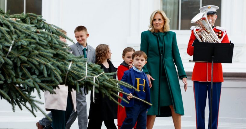 First lady Jill Biden oversees the arrival of the 2023 White House Christmas tree in Washington on Nov. 20 with children of military families.
