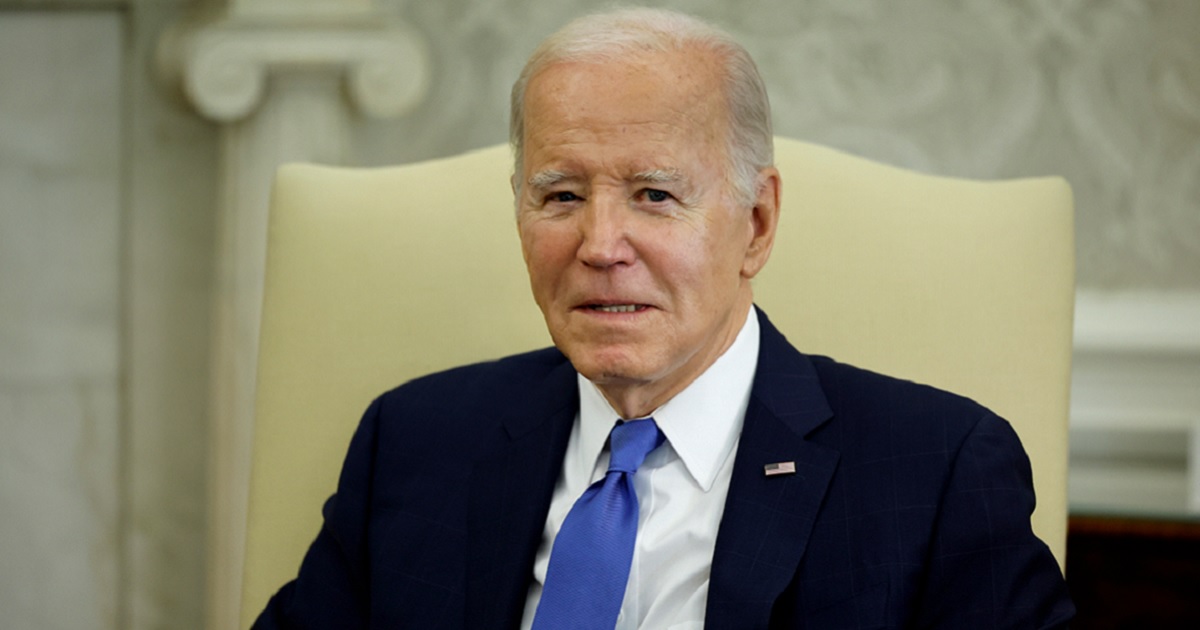 President Joe Biden appears to grimace while fielding questions from reporters Friday in the Oval Office.