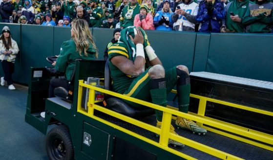 Green Bay Packers running back Aaron Jones is carted off the field during the first half of an NFL football game against the Los Angeles Chargers on Sunday in Green Bay, Wisconsin.
