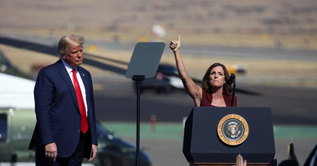 Former U.S. President Donald Trump watches as Senator Martha McSally (R-AZ) speaks at a Make America Great Again campaign rally on October 19, 2020 in Prescott, Arizona.