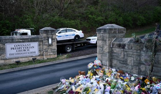 Police cars damaged during a shooting are removed from the Covenant School campus in Nashville, Tennessee, on March 28.