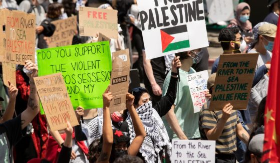 Anti-Israel protesters hold signs in Los Angeles on May 15, 2021.