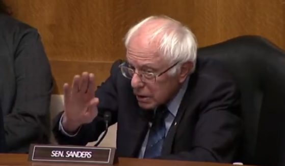 Sen. Bernie Sanders gestures for calm as a Senate hearing grew heated on Monday.