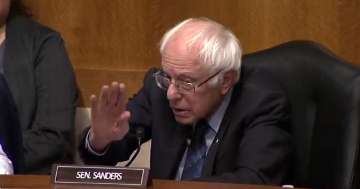 Sen. Bernie Sanders gestures for calm as a Senate hearing grew heated on Monday.
