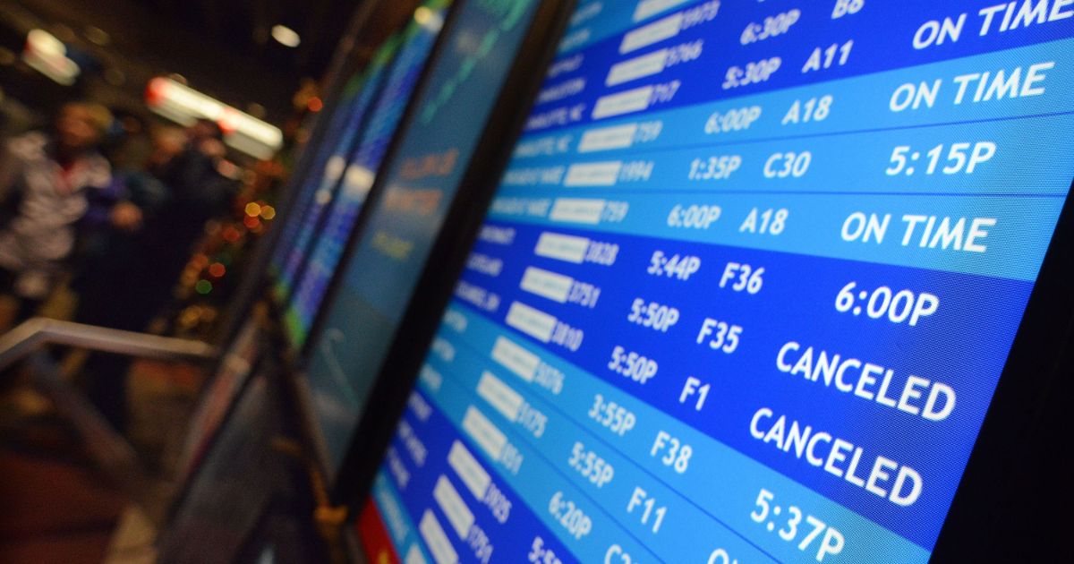 Flight departure displays indicate delayed or canceled fights at Philadelphia International Airport on Nov. 26, 2014, in Philadelphia.
