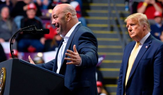 Former US President Donald Trump (R) looks on as Ultimate Fighting Championship (UFC) President Dana White addresses a "Keep America Great" rally in Colorado Springs, Colorado, on February 20, 2020.