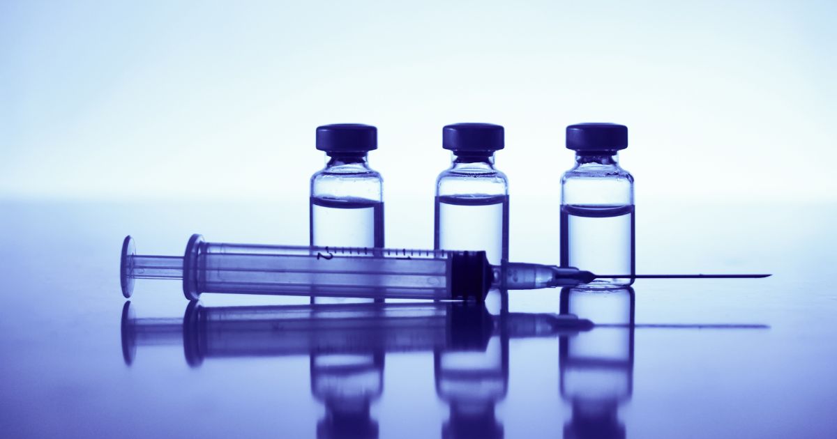 A syringe and vials are seen in this stock image.