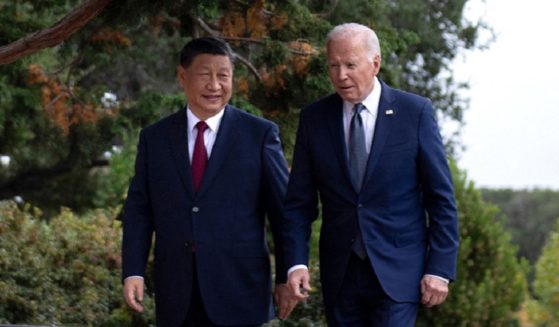 Chinese President Xi Jinping and President Joe Biden walk together Wednesday during the Asia-Pacific Economic Cooperating summit in San Francisco.