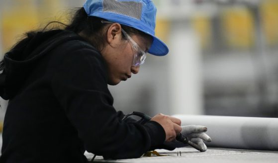 An employee works inside the Hanwha Qcells Solar plant in Dalton, Georgia, on Oct. 16.