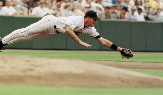 Baltimore Orioles third baseman Ryan Minor dives for a ball hit by the Detroit Tigers' Brad Ausmus during a game in Baltimore on Aug. 8, 1999. Minor died on Friday.