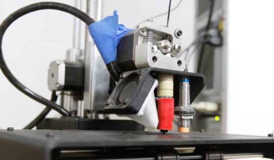 An undated stock photo shows a 3-D printer at work.