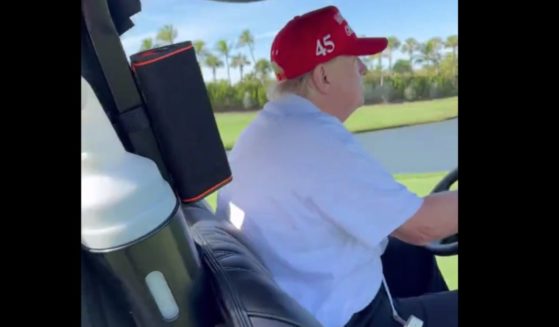 Donald Trump driving a golf cart