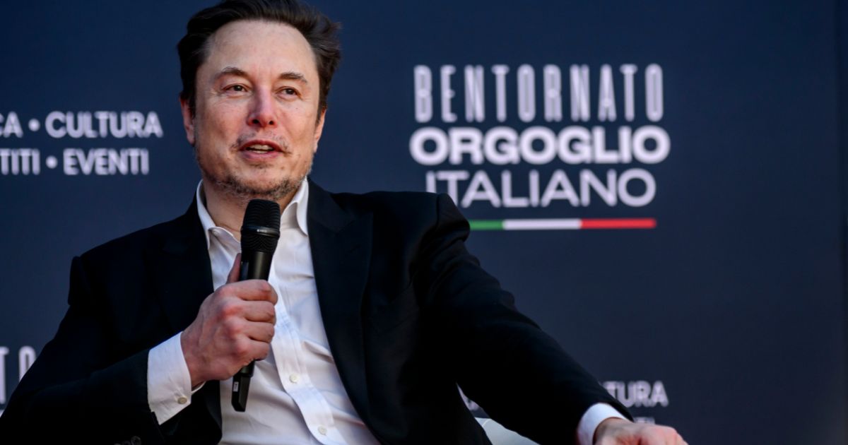 Tesla CEO Elon Musk peaks at the Atreju political convention in Rome, Italy, on Friday.