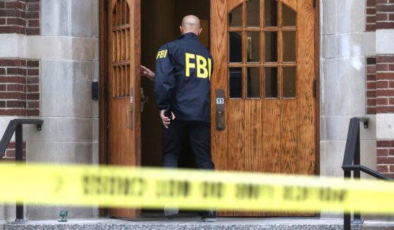An FBI agent enters Berkey Hall on the campus of Michigan State University in East Lansing, Michigan, on Feb. 16.