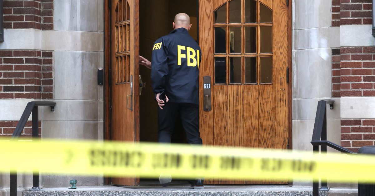 An FBI agent enters Berkey Hall on the campus of Michigan State University in East Lansing, Michigan, on Feb. 16.