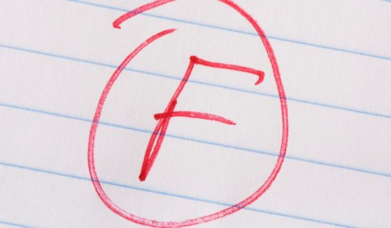 This stock photo shows an "F" received as a grade marked in red pen.