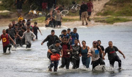 Illegal immigrants wade through the Rio Grande to cross into the United States from Mexico in Eagle Pass, Texas, on Sept. 27.