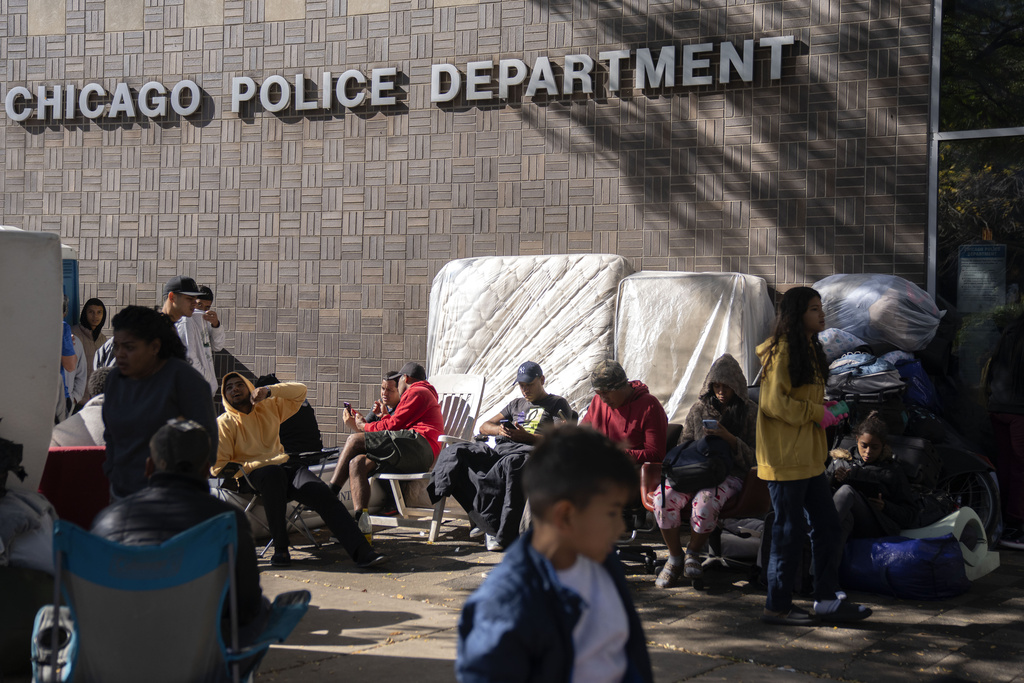 Migrants are camped outside of the 1st District police station, Oct. 7, in Chicago.