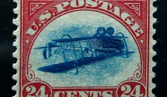 This photograph shows an "Inverted Jenny" stamp, which depicts a plane upside down due to a printing error. These stamps can be worth a fortune.
