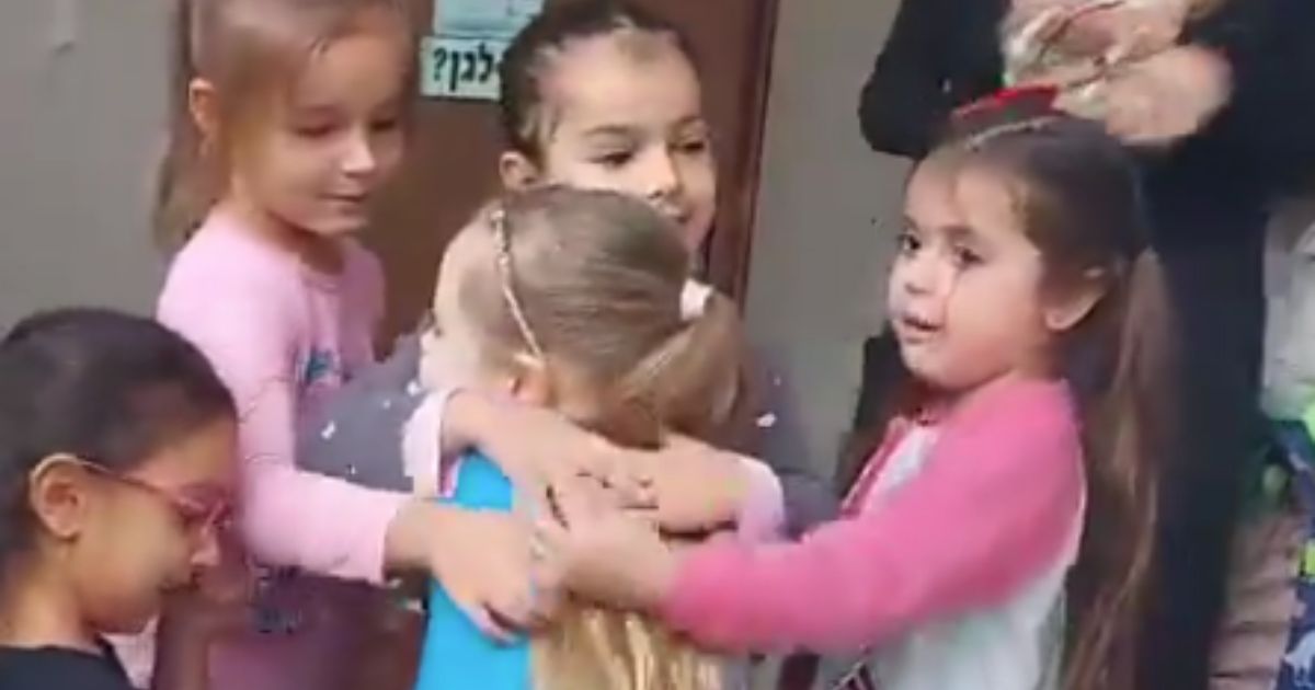 Emilia Aloni, center, was greeted with hugs from her kindergarten classmates on her first day back in class after being held captive by Hamas terrorists for seven weeks.