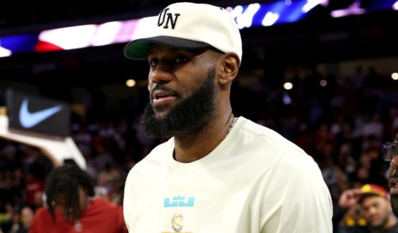 NBA star LeBron James finds his seat prior to the game between the USC Trojans and the Long Beach State 49ers in Los Angeles, California, on Sunday.