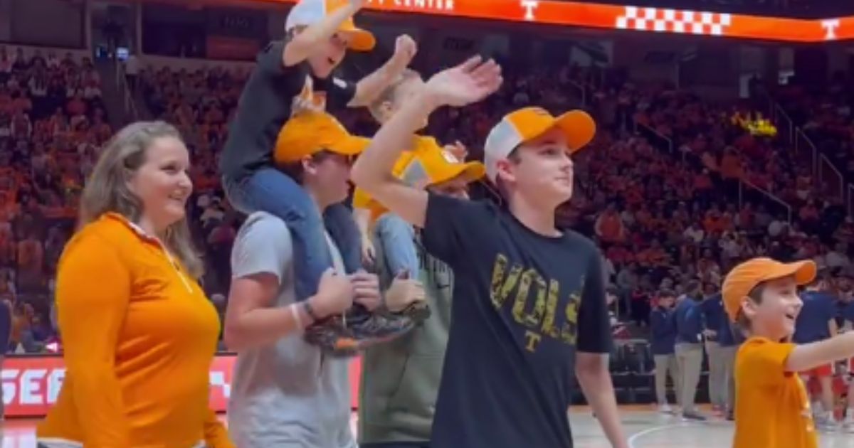 On Dec. 9, the family of Lieutenant Commander Zachary Smith attended a Tennessee Volunteers basketball game in Knoxville, Tennessee, and took the court during a commercial break to hear a special message from the deployed husband and father, but then they got a special surprise.
