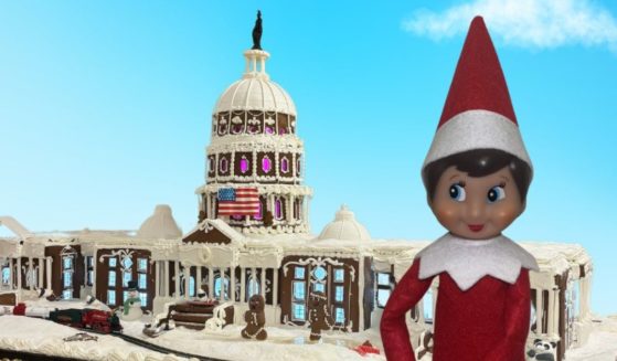 Nutmeg the elf is seen with a gingerbread version of the U.S. Capitol.