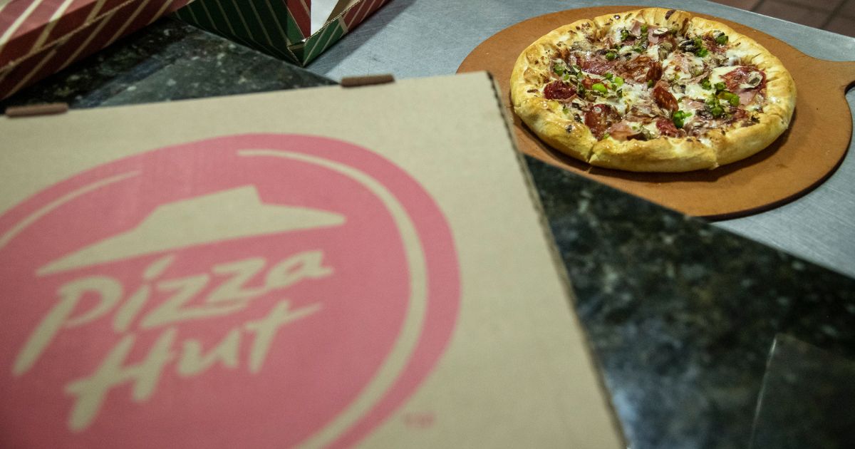 Pizza is ready for a delivery at a Pizza Hut store in Caracas, Venezuela, on Nov. 30, 2020. Pizza Huts in California have announced 1,200 layoffs as a result of a new minimum wage law.