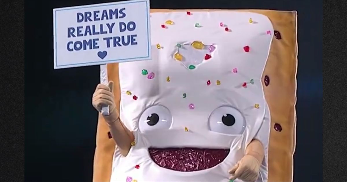 The giant Pop Tart character waved a sign saying "Dreams Really Do Come True" as it was lowered into the super-sized toaster.