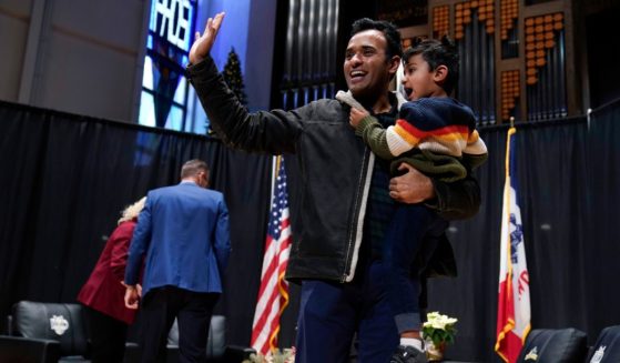 Republican presidential candidate and businessman Vivek Ramaswamy holds his son Karthik as he walks off stage during U.S. Rep. Randy Feenstra's Faith and Family with the Feenstras event, Saturday in Sioux Center, Iowa.