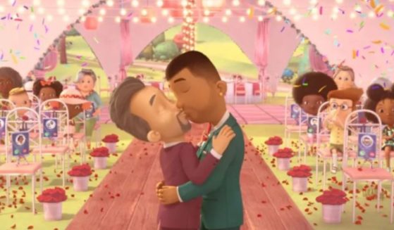 A still image from the animated show "Ada Twist, Scientist," shows two men kissing at their wedding, in front of a room filled with children.