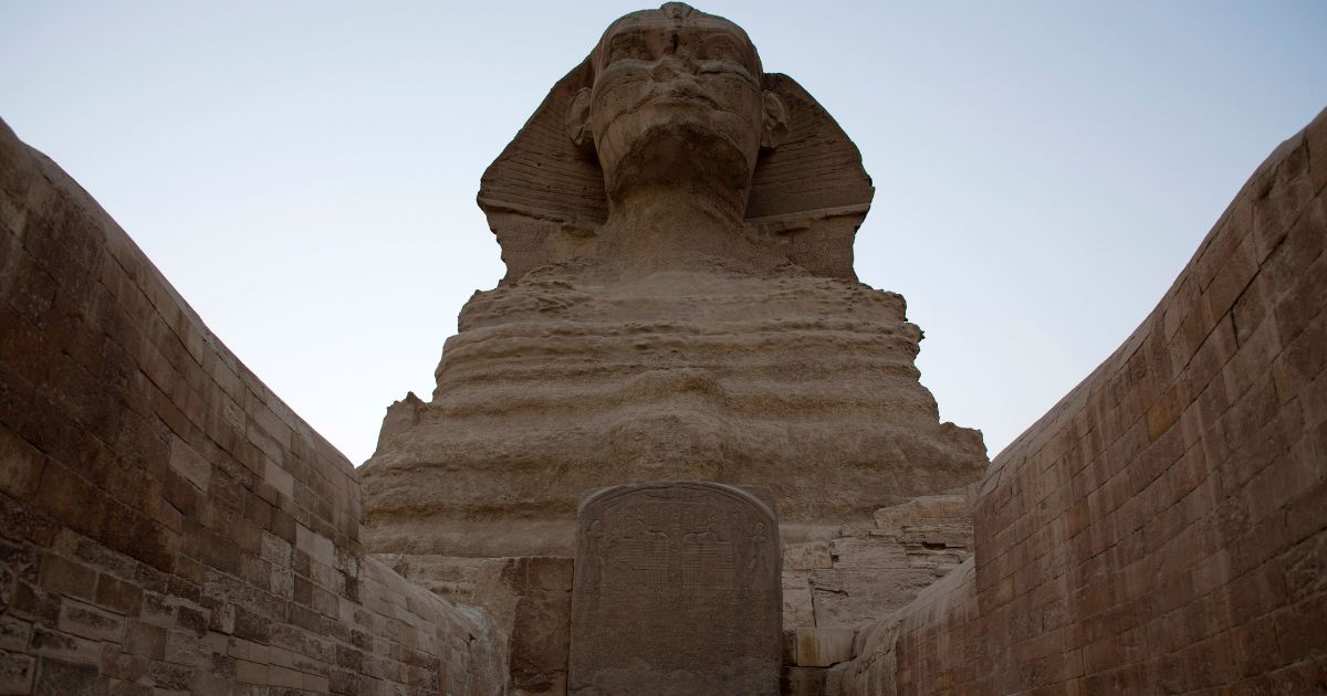 The Great Sphinx stands adjacent to the Great Pyramids of Giza following the completion of restoration work in preparation for the reopening of the courtyard around its base, in Giza, Egypt, on Nov. 9, 2014.