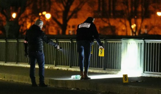 Forensic police work the scene of a fatal stabbing in Paris on Saturday.