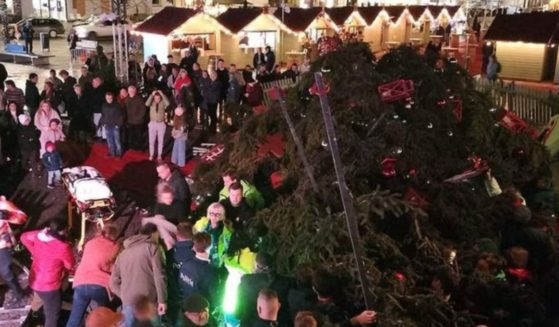The collapse of a Christmas tree in Belgium killed a 63-year-old woman and injured two other people.