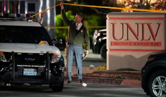 A police officer walks under crime scene tape on the University of Nevada Las Vegas campus following a shooting on the premises on Wednesday.