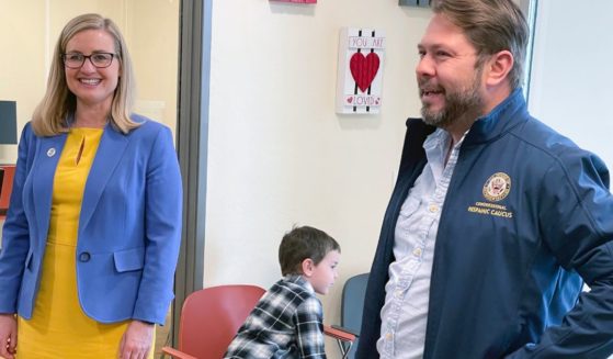 U.S. Rep. Ruben Gallego, D-Ariz., and his ex-wife, Phoenix Mayor Kate Gallego, tour an affordable housing development in Phoenix along with their 6-year-old son, Michael, on March 19.