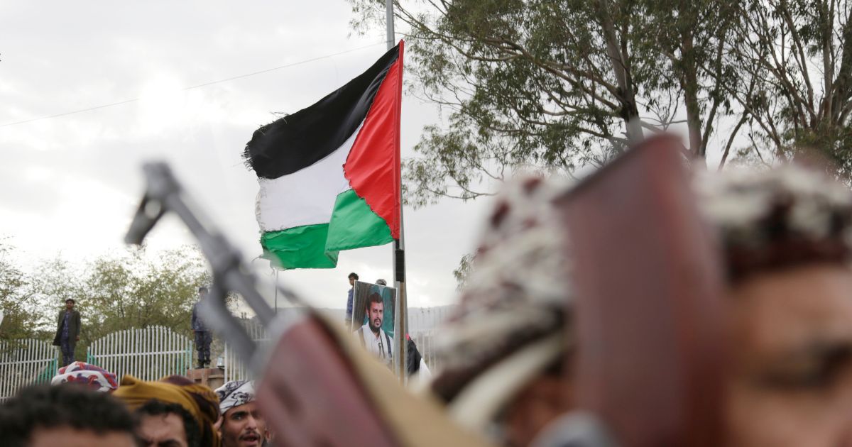 Demonstrators lift guns and Palestinian flags during a pro-Palestinian protest on Friday in Sana'a, Yemen.