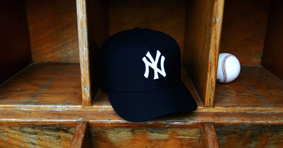 A New York Yankees cap and a baseball are seen at Legends Field on Feb. 25, 2005, in Tampa, Florida.