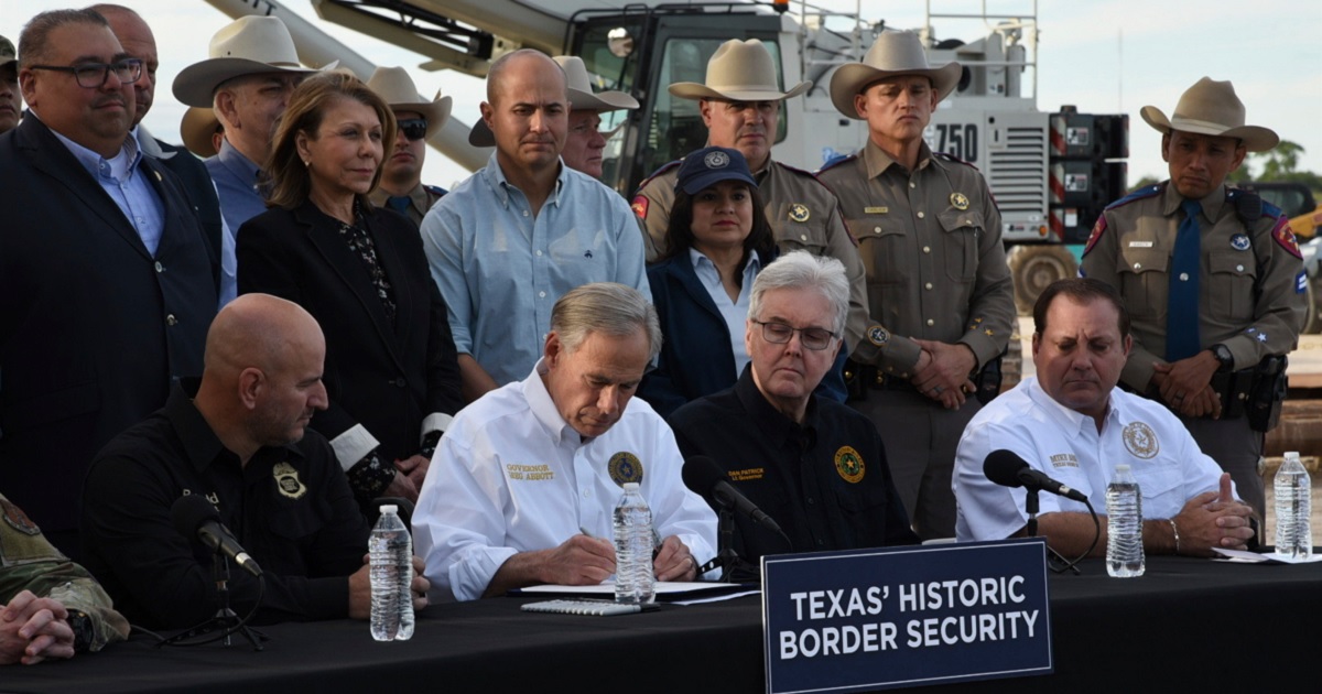 Texas Gov. Greg Abbott uses a border wall construction site in Brownsville, Texas, as a backdrop on Monday to sign bills that will broaden his border security plans and add funding for more infrastructure to deter illegal immigration.