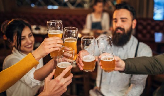 People drink beer in this stock image.
