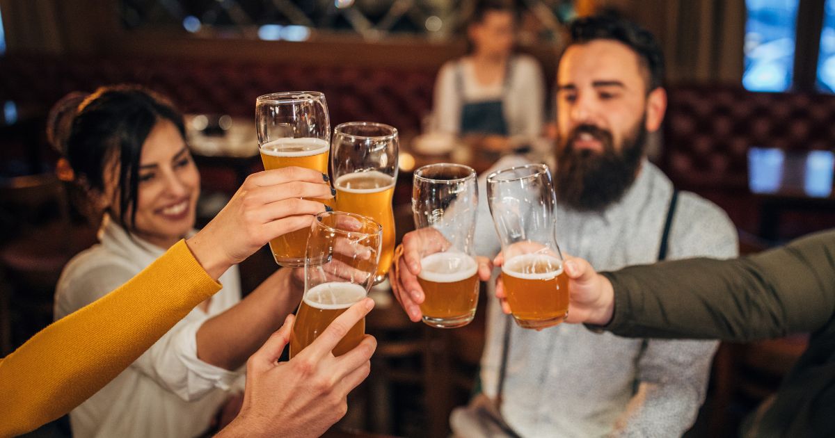 People drink beer in this stock image.