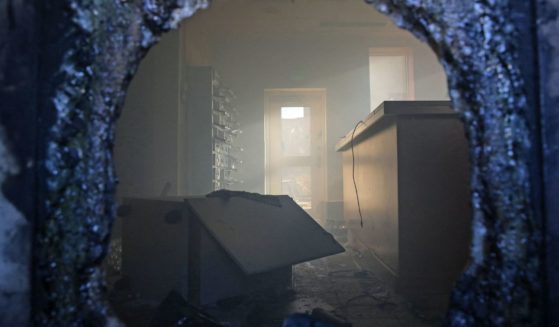 A picture taken through a broken window shows a vandalized room in the US embassy in Iraq's capital Baghdad, on December 31, 2019, after supporters and members of the Hashed al-Shaabi military network breached the outer wall.