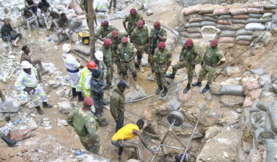 Zambian Army special forces officers follow the rescue operation of miners